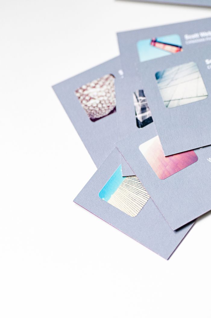 home-img High angle view of abstract design business cards with cutouts on a white background.